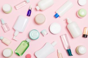 Group of plastic bodycare bottle Flat lay composition with cosmetic products on pink background empty space for you design Set of White Cosmetic containers, top view with copy space